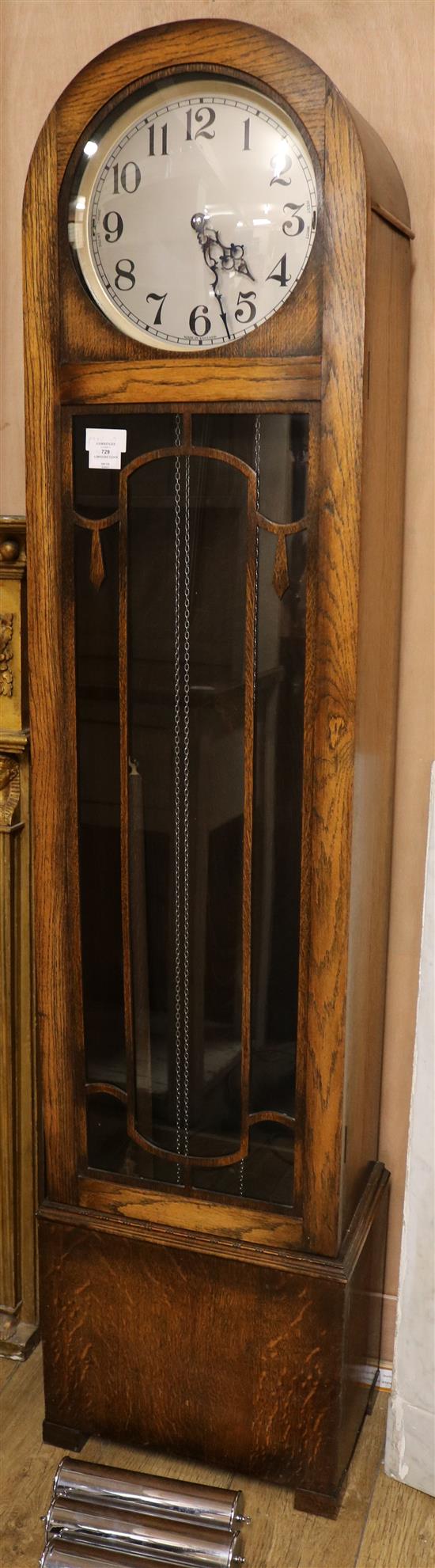 A 1930s oak cased thirty hour chiming longcase clock, H.6ft